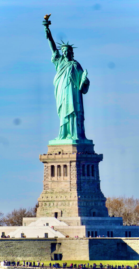 The statue of liberty on a clear sunny day.